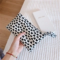 Detail of seersucker makeup pouch featuring black heart patterns and a fabric handle - White With Heart
