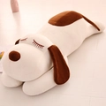 Large plush puppy in white and brown lying flat on a light wood floor for sleeping - 32cm / White