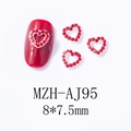 Macro shot of red hollow heart nail art charms with rhinestones, 8x7.5mm alloy metal studs - Red Hollow Rhinestone Heart (AJ95)
