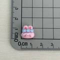 Macro shot of a tiny pink resin rabbit charm with a blue flower for DIY crafts - Pink Rabbit with Three Flowers