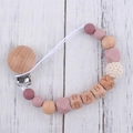 Detailed macro view of pink silicone beads and wooden clip for baby pacifier chain - Dusty Rose