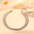Detail view of silver snake bone chain bracelet with lobster clasp on soft peach fabric - Silver Bracelet (N712)