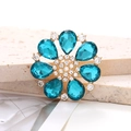 Macro detail of alloy flower shoe charm with peacock blue pear-shaped rhinestones - Lake Blue