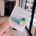 Cute pineapple hair clip with blue heart sequins on a white display card - Transparent Pineapple