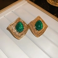 Vintage gold earrings with emerald green teardrop stones on white jewelry tray - 138# Emerald Green Teardrop Vintage Style (925 Sterling Silver Earring Post)