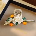 Elegant floral metal hair claw with white pearls and orange fruit accents in gold finish - Pearl Flower Orange Fruit Claw