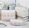 Set of three pink floral quilted cotton cosmetic bags in various sizes for travel - Rose Lace
