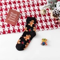 Black Christmas cotton socks with gingerbread man patterns on festive background - One Size / Black