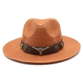 Straw cowboy hat with bull head emblem and brown leather strap on white background - Caramel color