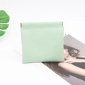 Close-up of mint green crocodile pattern small pouch with automatic metal spring closure - Green