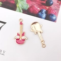 Detail of pink enamel guitar charms with white wings and gold-plated back view - Pink Guitar Wings (14x31mm)