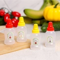 Set of four portable mini plastic squeeze bottles for condiments with red and yellow caps - Honey + Tomato + Soy Sauce + Salad 4Pcs Set