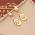 Detail of vintage gold-plated drop earrings featuring light green stones and sunburst texture - Light Green Gear Edge Oval Style(11#)
