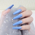 Detail of glossy bright blue long coffin ballerina press-on nails on a tulle background - Blue (CBLL-39)