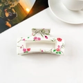 Detail of square hair claw clip with floral pattern next to a coffee cup and card - Cream White Rose Floral