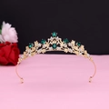 Close-up of vintage gold crown with green emerald stones and romantic rose background - No.12 KC Gold (Green Stone)
