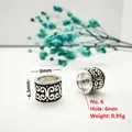 Macro detail of antique silver barrel beads with 6mm large hole and engraved floral patterns - Style 6 (Scroll Pattern)