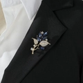 Elegant gold leaf brooch with blue crystals and diamonds pinned on a black suit blazer - Blue Leaf Style (Z429)