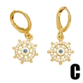 Golden evil eye earrings with rudder pendant and cross elements on a white background - Ship's Wheel Evil Eye Style (C)