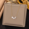 Elegant gold necklace with four gradient white pearls on a stylish jewelry display box - Four Artificial Pearls Necklace (H303) / Gold