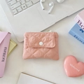 Pink quilted fabric coin purse with white resin snap button on a desktop workspace - Nude Pink