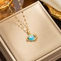 Close-up of gold-plated evil eye necklace with blue iris and pavé micro-inlay - 315 Golden Eyelashes
