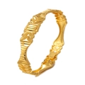 Detailed view of gold bangle featuring intricate leaf patterns and geometric textures - Style 7