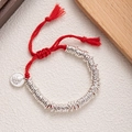 Handcrafted red woven rope bracelet with silver rings and traditional God of Wealth charm - Red-Deity Plate