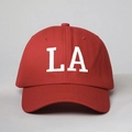 Close-up of white LA letter embroidery on premium red cotton twill baseball cap - One Size / Red