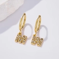 Macro shot of gold letter earrings featuring pave-set rhinestones and polished finish - Letter W (Style: 0229)