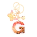 Resin letter G keychain with colorful glitter and pink butterfly charm in gold finish - Letter G