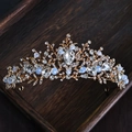 Elegant gold alloy bridal crown with white rhinestones on dark wooden tray - 27# Luxury Gold Base Rhinestone Style