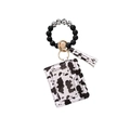 Detail of cow print wristlet keychain with silicone beads and leather card holder - Black White Cow Print