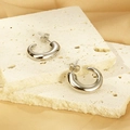 Detailed view of silver thick C-shaped metal hoop earrings on textured stone pedestals - Steel Color (KE112668-KFC)