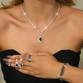 Close-up of elegant silver jewelry set featuring black pear-cut stones and zircon accents - Four-Piece Set / Silver Black