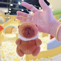 Brown plush Capybara keychain accessory with silver metal clip ring held in hand - Chick Hat Dark Brown + Silver Clip