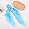 Light blue satin scrunchie with long ribbons on a minimalist tray for hair styling - Light Green
