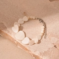 Natural shell heart bead bracelet with silver adjustable chain on stone background - White Heart Shell Bracelet