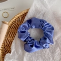 Detailed view of dark blue satin scrunchie with silky shine texture on a rustic tray - Navy Blue