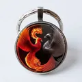 Round metal keychain featuring a red and black yin-yang phoenix pattern glass dome - Red Grey Dual Phoenix