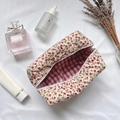 Floral quilted cosmetic bag with red flower patterns and red checkered lining interior - Red