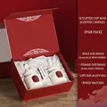 Red engagement gift box with white ceramic goddess candles in bluebell and freesia scents - Bluebell + Freesia Engagement Edition