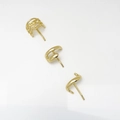 Detail of three minimalist gold alloy ear studs with textured and twisted metallic finishes - 3-Piece Stud Earring Set / Gold
