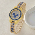 Luxury women's gold quartz watch featuring vibrant blue crystals and a chic chain strap - 5-558 Gold Blue