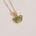 Golden bear necklace featuring a green zircon micro-paved pendant on a sand background - 14K Gold Green Zircon