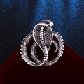 Detailed macro view of retro silver snake brooch with crystal scales on velvet - Antique Silver Cobra