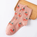 Pink modal socks featuring red strawberry patterns and elegant ruffle cuffs on wood tray - Orange Pink Strawberry