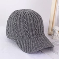 Detail view of dark grey knitted baseball cap featuring thick cable knit patterns - M (56-58cm) / Gray