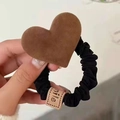 Elastic black scrunchie featuring a brown plush heart charm and a small smile tag - Coffee Suede Heart