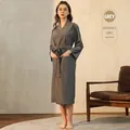 Women's dark grey waffle robe with tie-waist belt and pockets in a cozy home setting - M / Women-Grey